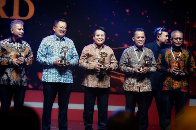 Direktur Utama BSI Hery Gunardi (tengah) saat menerima penghargaan dari OJK atas implementasi Program Satu Rekening Satu Pelajar (KEJAR) kategori Bank Umum Syariah Terbaik dari OJK di JI Expo Kemayoran Jakarta, Kamis (22/8/2024).